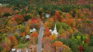 AX150_064 - 5.5K aerial stock footage orbiting small town, Union Church, rural homes, autumn, Buckfield, Maine