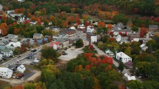 AX150_087 - 5.5K stock footage aerial video orbiting small rural town with colorful foliage, autumn, Paris, Maine