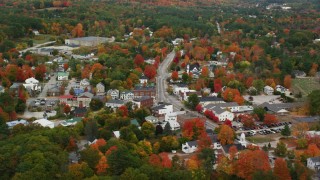 AX150_088 - 5.5K aerial stock footage orbiting a small rural town, fall foliage throughout in autumn, Paris, Maine