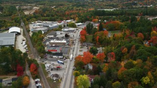AX150_093 - 5.5K stock footage aerial video flying over Main Street, businesses, small town in autumn, Paris, Maine