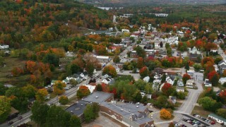 AX150_096 - 5.5K aerial stock footage flying over small rural town, approaching Main Street, autumn, Norway, Maine