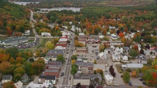 AX150_096E - 5.5K aerial stock footage flying over Main Street through small rural town, tilt down, autumn, Norway, Maine