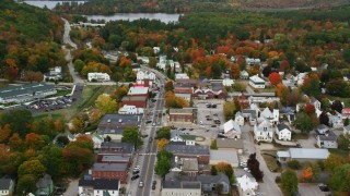 AX150_097 - 5.5K stock footage aerial video flying over Main Street through small rural town, tilt down, autumn, Norway, Maine