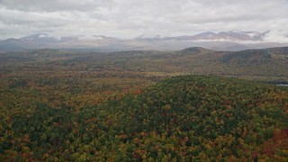 AX150_141E - 5.5K aerial stock footage flying over Peaked Hill, colorful forest, approach White Mountains, autumn, Lovell, Maine