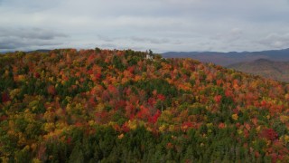 AX150_165 - 5.5K aerial stock footage flying by an isolated home, colorful forest on White Mountains, New Hampshire