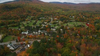 AX150_172 - 5.5K aerial stock footage orbiting a small rural town, colorful trees in autumn, Jackson, New Hampshire