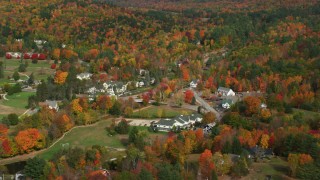 AX150_178 - 5.5K aerial stock footage orbiting a small rural town, colorful foliage, autumn, Jackson, New Hampshire