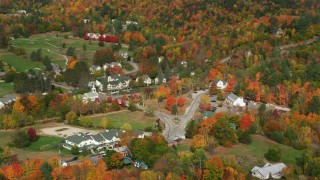 AX150_179 - 5.5K aerial stock footage of a small rural town, Jackson Community Church, The Wentworth, autumn, Jackson, New Hampshire