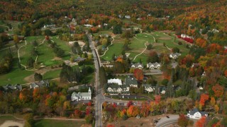 AX150_180 - 5.5K aerial stock footage approaching, flying over small rural town, Wentworth Golf Club, autumn, Jackson, New Hampshire