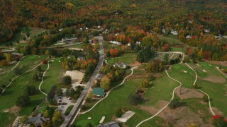 AX150_181 - 5.5K aerial stock footage flying over small rural town, Wentworth Golf Club, approach cemetery, autumn, Jackson, New Hampshire