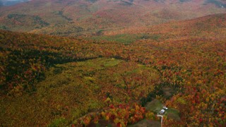 AX150_186 - 5.5K aerial stock footage flying over isolated home, forest, autumn, overcast, White Mountains, New Hampshire