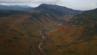 AX150_194 - 5.5K aerial stock footage of Highway 302, forest, Mount Willey, autumn, rainy, White Mountains, New Hampshire