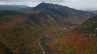 AX150_195 - 5.5K aerial stock footage of Highway 302, Mount WIlley, forest, autumn, rainy, White Mountains, New Hampshire