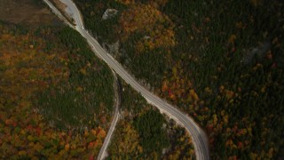 AX150_200 - 5.5K aerial stock footage of a bird's eye view over Highway 302, forest, reveal pond, autumn, White Mountains, New Hampshire