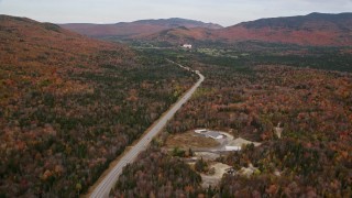 AX150_201 - 5.5K aerial stock footage flying over forest, Highway 302, autumn, overcast, White Mountains, New Hampshire