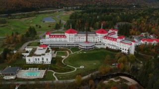 AX150_209 - 5.5K stock footage aerial video orbiting Omni Mount Washington Resort, golf club, autumn, Carroll, New Hampshire
