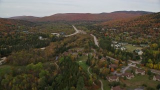 AX150_211 - 5.5K aerial stock footage approaching Base Station Road, Highway 302, over rural homes, Carroll, New Hampshire