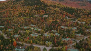 AX150_212 - 5.5K aerial stock footage flying by rural homes, colorful trees, autumn, Bretton Woods, Carroll, New Hampshire