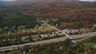 AX150_240E - 5.5K aerial stock footage approaching small rural town, Interstate 93, autumn, Franconia, New Hampshire
