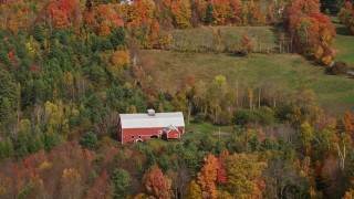 AX150_254 - 5.5K aerial stock footage flying by a red barn, colorful foliage, autumn, Sugar Hill, New Hampshire