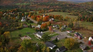 AX150_255E - 5.5K aerial stock footage approaching a small rural town, colorful foliage in autumn, Sugar Hill, New Hampshire