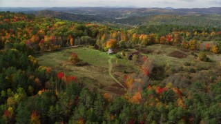 AX150_264 - 5.5K aerial stock footage approaching an isolated rural home, tilt down, autumn, Lisbon, New Hampshire