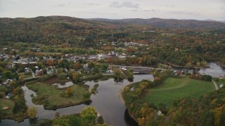 AX150_283E - 5.5K aerial stock footage flying over small farms Ammonoosuc River, approach rural town, autumn, Woodsville, New Hampshire