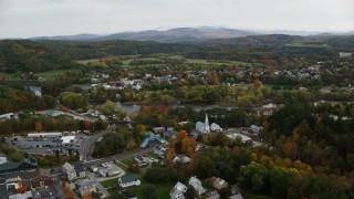 AX150_289 - 5.5K aerial stock footage flying by small rural town, colorful foliage, autumn, Woodsville, New Hampshire and Wells River, Vermont