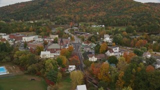 AX150_292E - 5.5K aerial stock footage flying over farm field, Hospital Road, small rural town, autumn, Woodsville, New Hampshire
