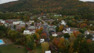 AX150_294 - 5.5K aerial stock footage flying over small town, approach Bath-Haverhill Bridge, autumn, Woodsville, New Hampshire