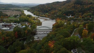 AX150_296 - 5.5K stock footage aerial video of small bridges across Connecticut River, small towns autumn, Woodsville, New Hampshire and Wells River, Vermont