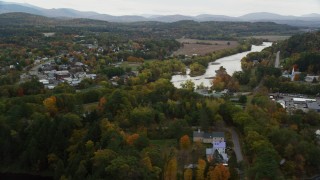 AX150_297 - 5.5K aerial stock footage orbiting small rural towns, Connecticut River, autumn, Woodsville, New Hampshire and Wells River, Vermont