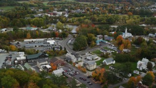 AX150_299 - 5.5K aerial stock footage of small rural towns, car dealership near Connecticut River, autumn, Wells River, Vermont