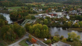 AX150_300 - 5.5K aerial stock footage flying over small rural towns, approach small bridges, Connecticut River, autumn, Wells River, Vermont and Woodsville, New Hampshire