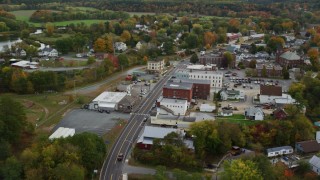 AX150_301 - 5.5K aerial stock footage flying over Central Street through small town, Connecticut River, autumn, Woodsville, New Hampshire