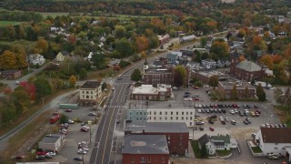AX150_301E - 5.5K aerial stock footage flying over Central Street through small town, Connecticut River, autumn, Woodsville, New Hampshire