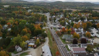 AX150_302 - 5.5K stock footage aerial video flying over Central Street, by a small rural town, autumn, Woodsville, New Hampshire