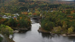 AX150_303 - 5.5K aerial stock footage of a small rural town, bridges, Connecticut River, autumn, Woodsville, New Hampshire and Wells River, Vermont