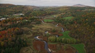 AX150_308E - 5.5K aerial stock footage approaching a small bridge, Interstate 91 across a small river, autumn, Wells River, Vermont