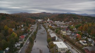 AX150_351E - 5.5K aerial stock footage flying over homes and Winooski River, approach downtown, Vermont State House, autumn, Montpelier, Vermont