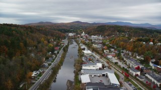 AX150_353 - 5.5K aerial stock footage flying over Winooski River, approach downtown, autumn, Montpelier, Vermont