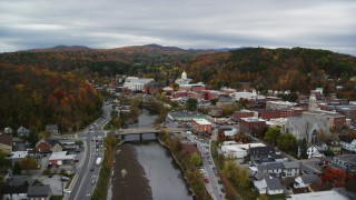 AX150_354 - 5.5K aerial stock footage flying over Winooski River, approach downtown, Vermont State House, autumn, Montpelier, Vermont