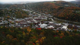 AX150_357 - 5.5K aerial stock footage flying by downtown buildings, colorful trees, autumn, Montpelier, Vermont