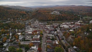 AX150_357E - 5.5K aerial stock footage flying by downtown buildings, colorful trees, autumn, Montpelier, Vermont