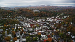 AX150_359 - 5.5K aerial stock footage flying by downtown buildings, colorful foliage, overcast, autumn, Montpelier, Vermont