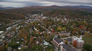 AX150_361E - 5.5K aerial stock footage flying by Vermont College of Fine Arts and downtown near homes, autumn, Montpelier, Vermont