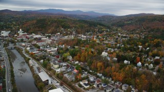 AX150_362 - 5.5K aerial stock footage flying by downtown in autumn, Winooski River, overcast sky, Montpelier, Vermont