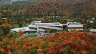 AX150_367 - 5.5K aerial stock footage orbiting office buildings and colorful trees in autumn, Montpelier, Vermont