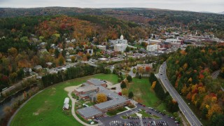 AX150_372 - 5.5K aerial stock footage flying by Montpelier High School, downtown, Vermont State House, autumn, Montpelier, Vermont