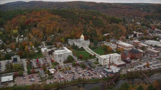 AX150_372E - 5.5K aerial stock footage flying by Montpelier High School, downtown, Vermont State House, autumn, Montpelier, Vermont